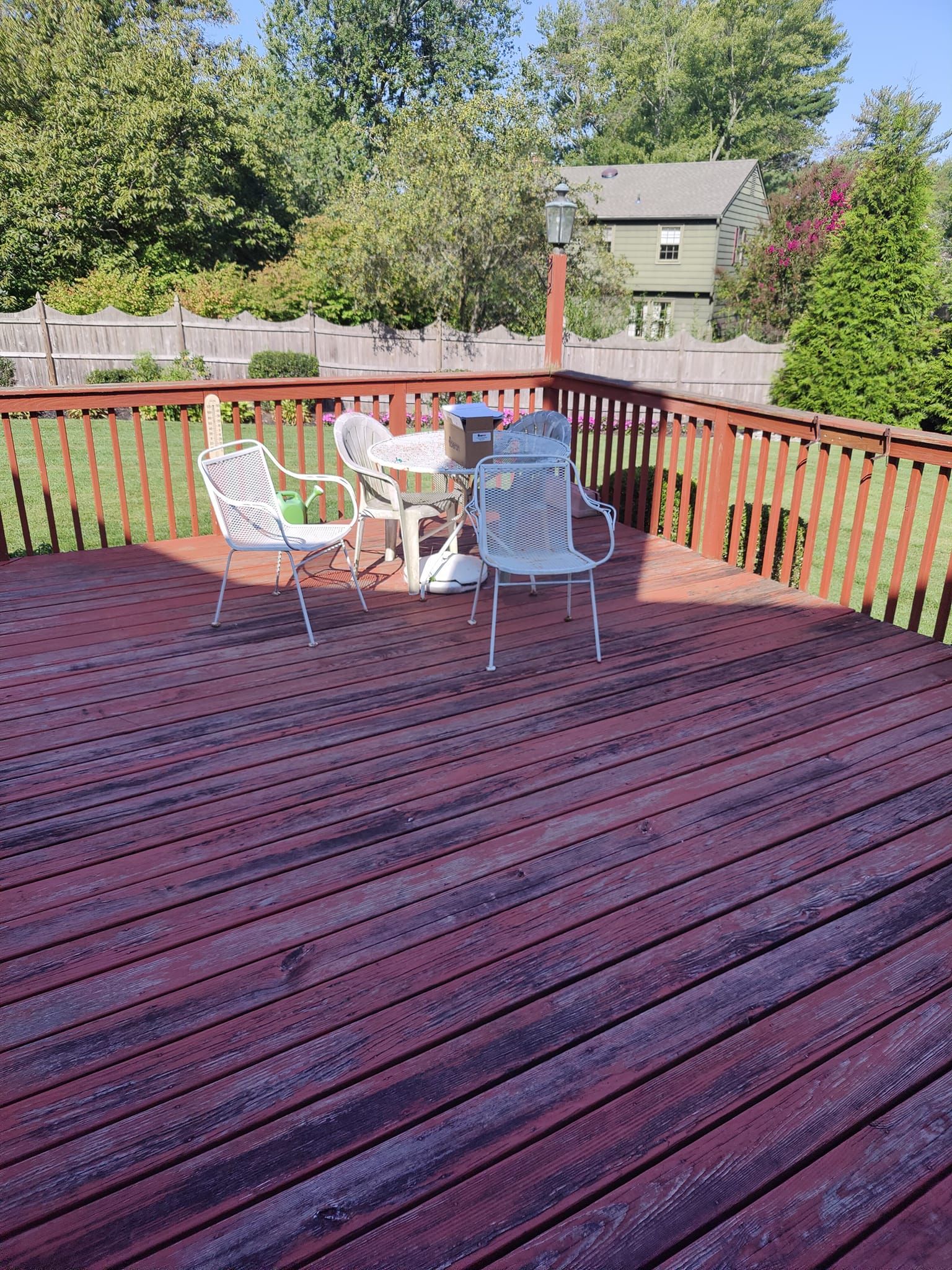 A wooden deck with a table and chairs on it.