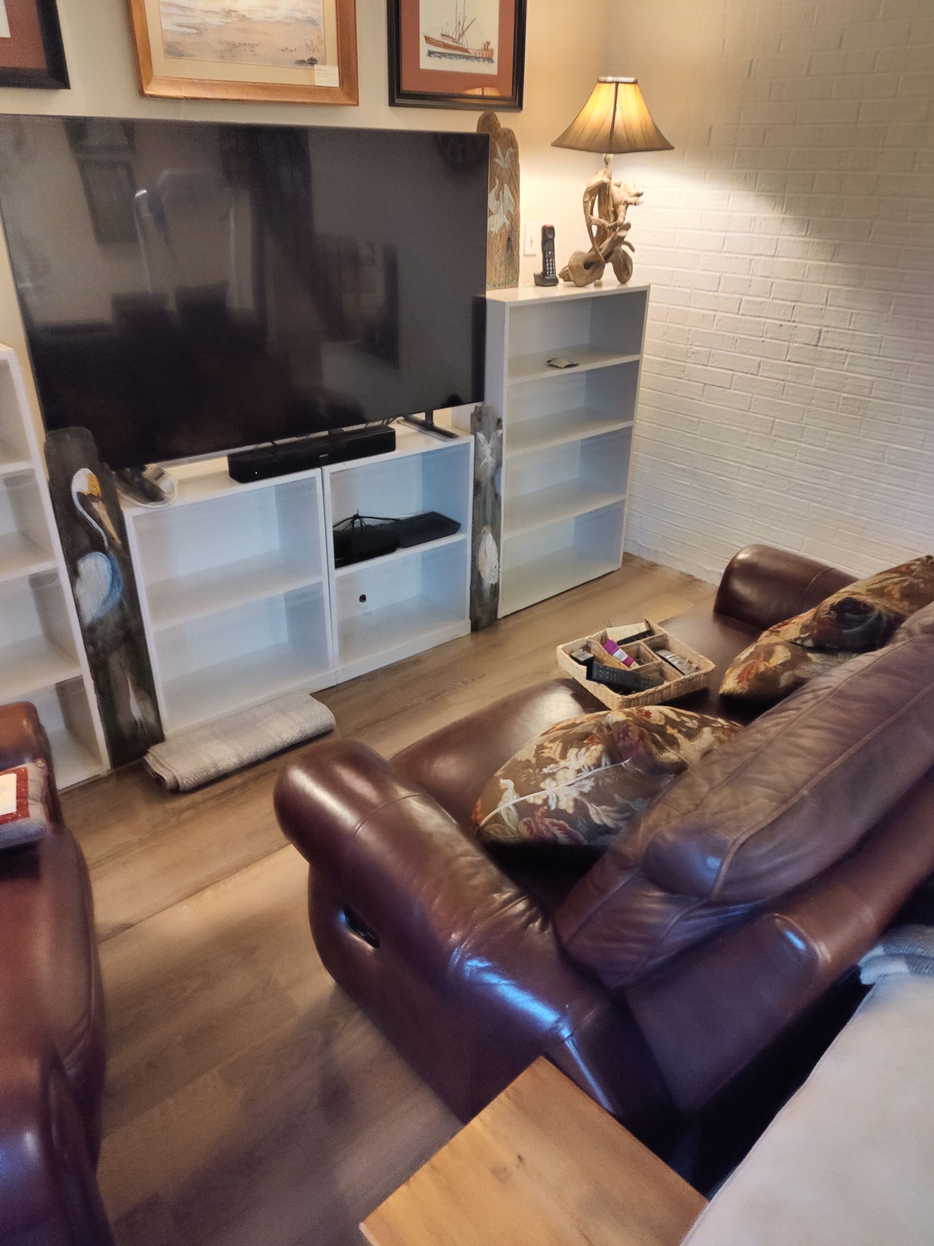 A living room with a couch and a flat screen tv.