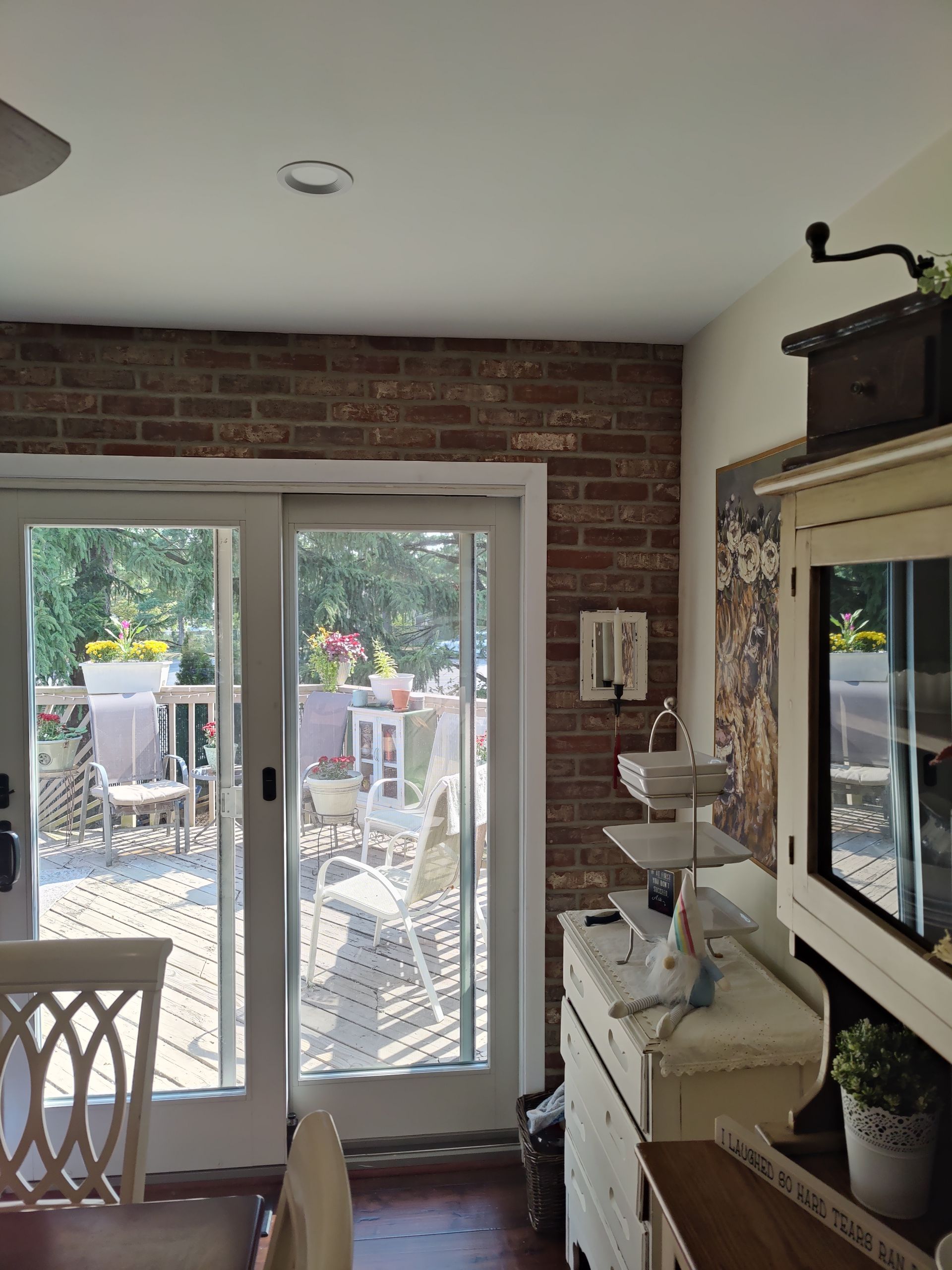 A kitchen with a sliding glass door leading to a deck.