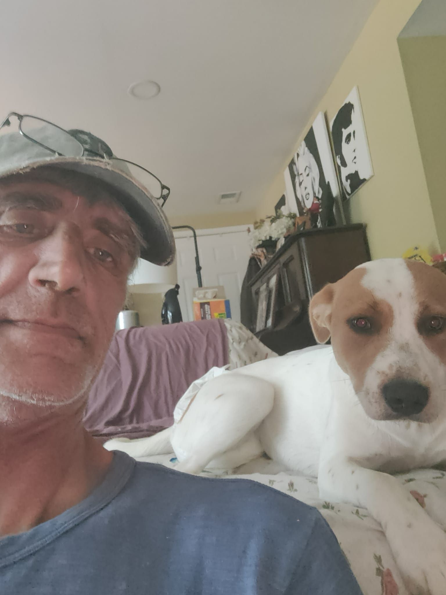 A man is taking a selfie with his dog.