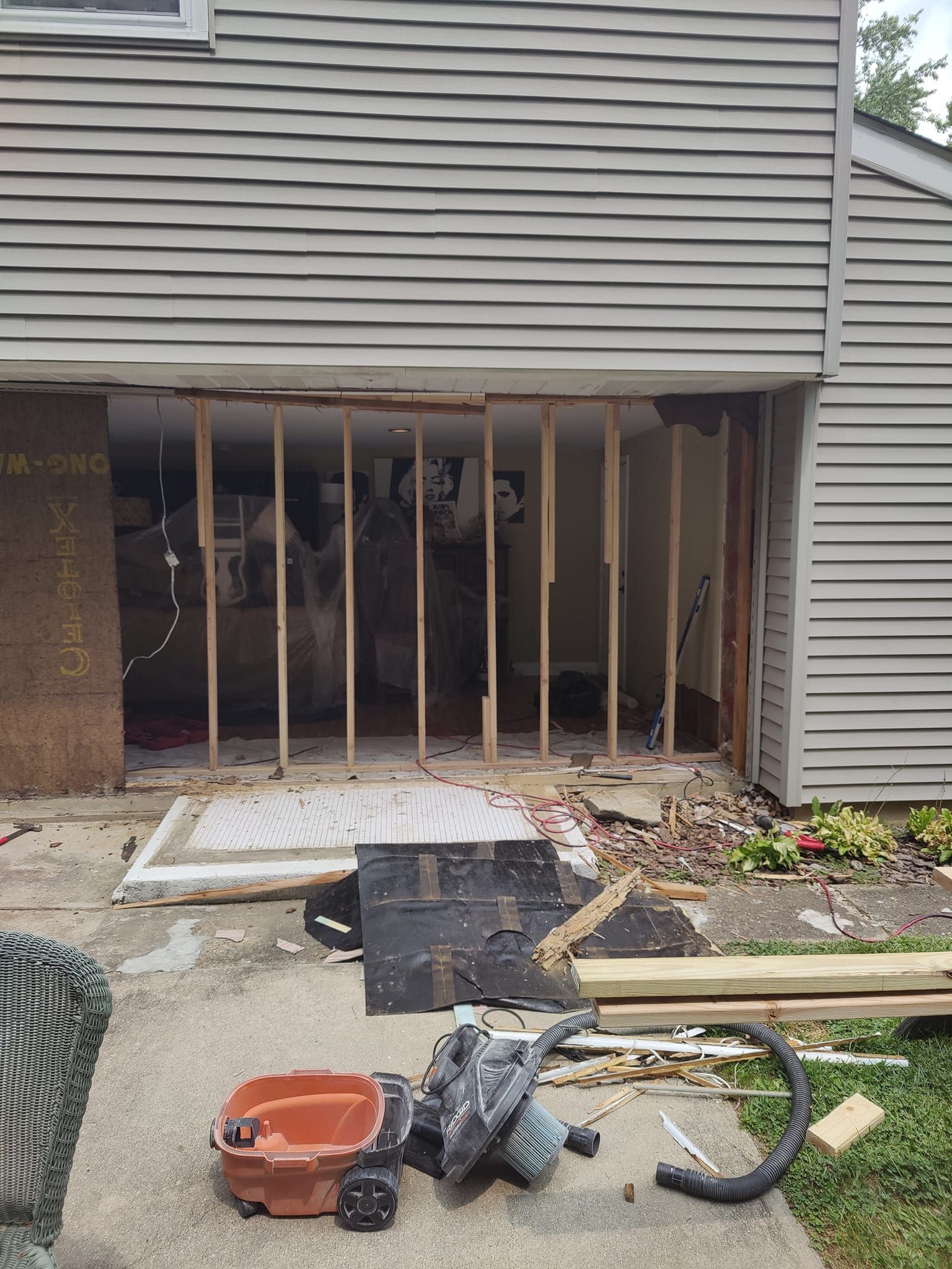 A garage door is being removed from a house.