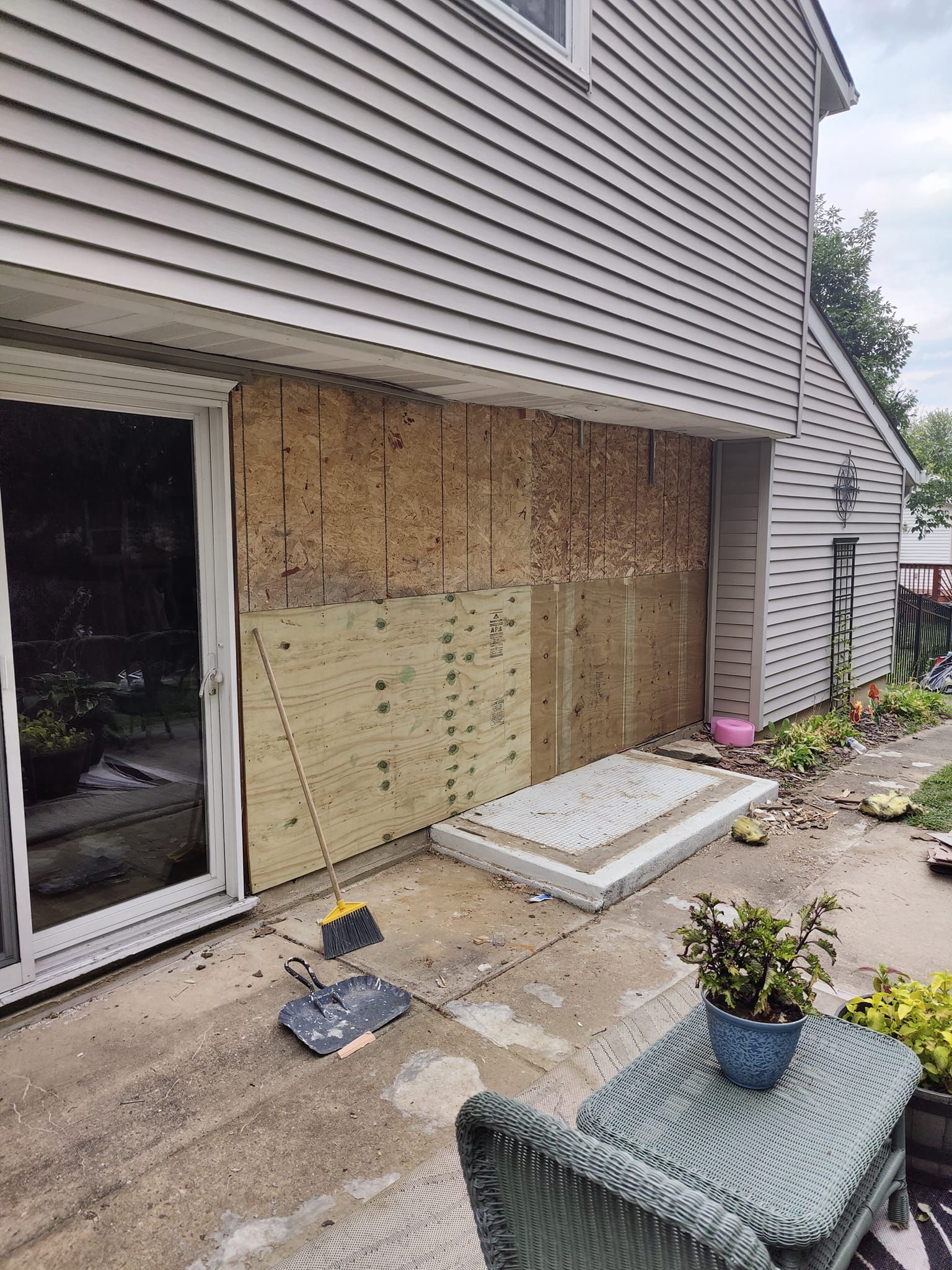 A house with a sliding glass door is being remodeled.