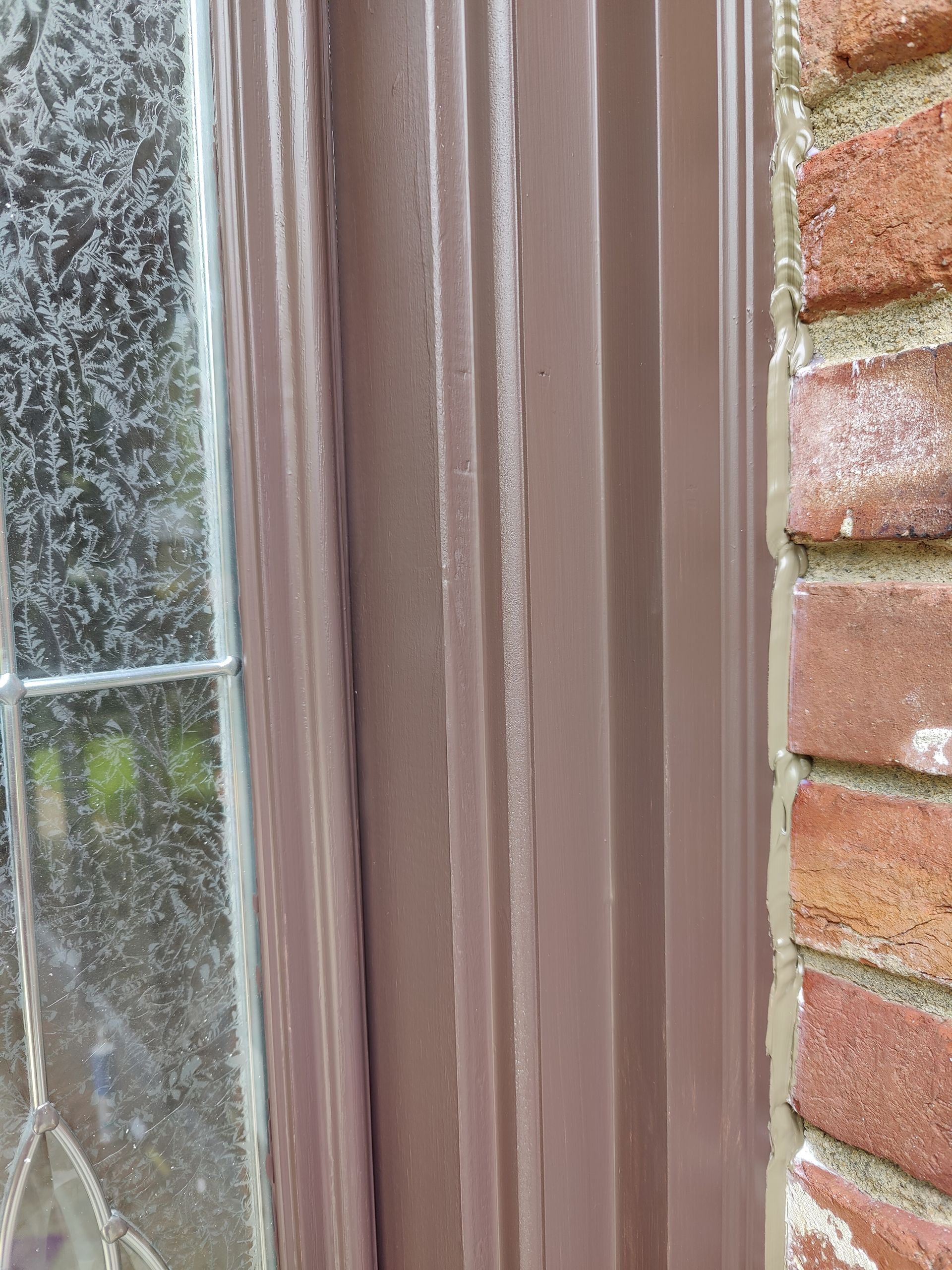 A close up of a window on a brick wall.