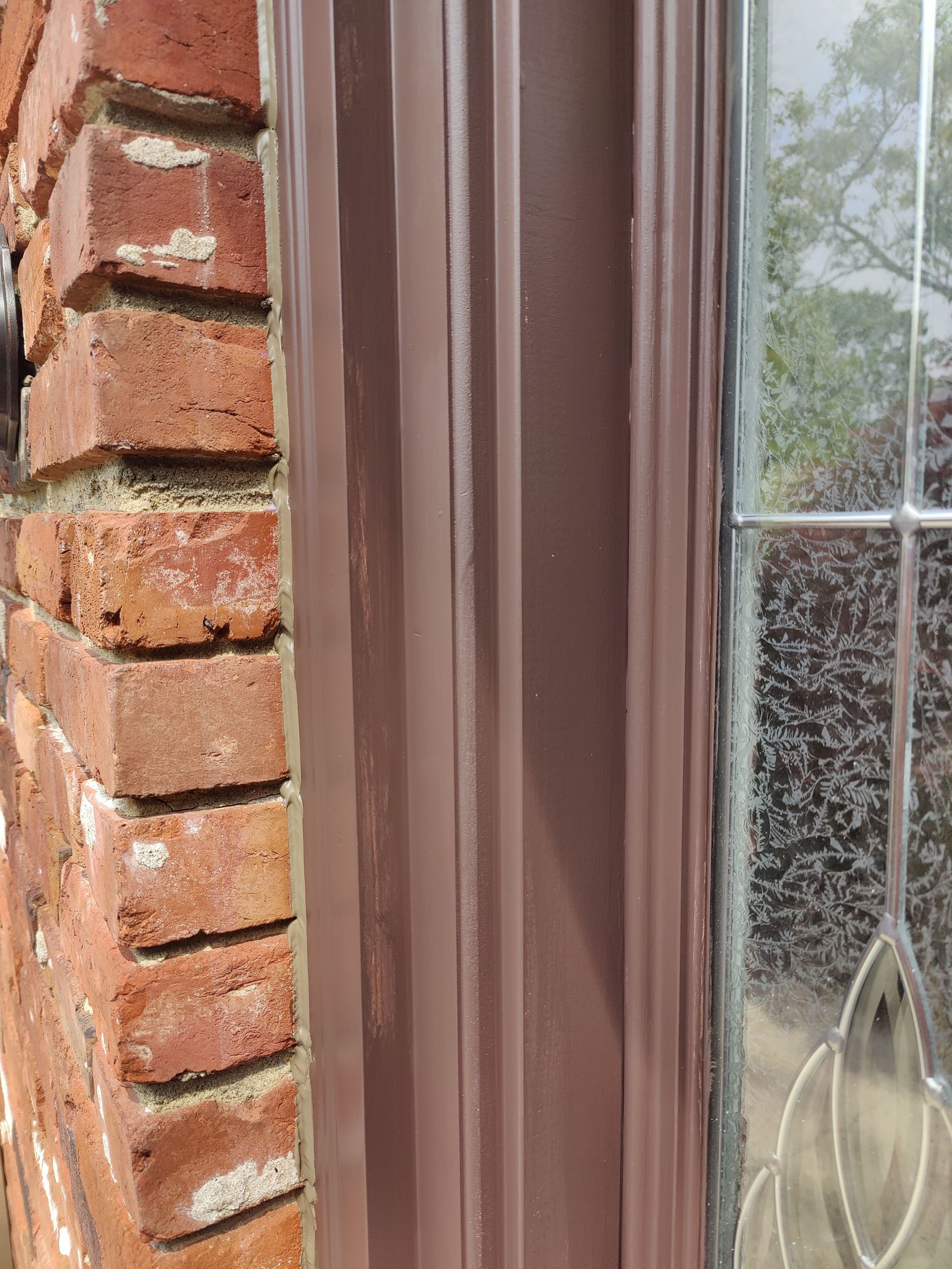 A close up of a window on a brick wall.