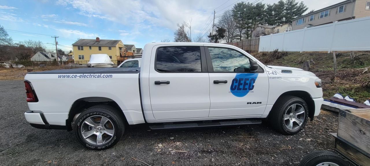 White Ram pickup truck with blue logo, parked outdoors.