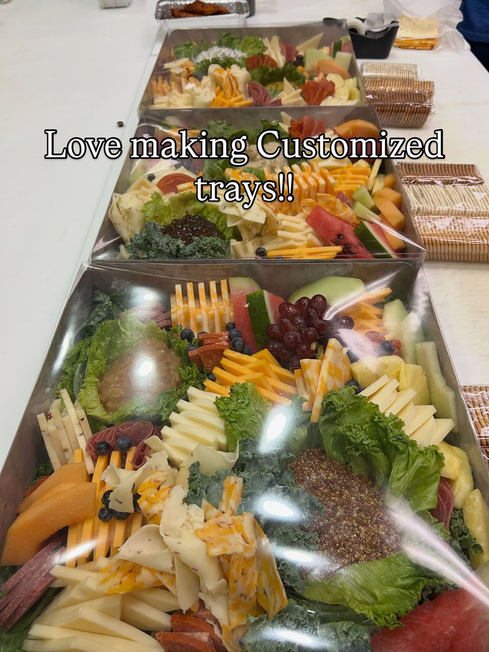 Appetizer tray with fruit, cheese, crackers, and vegetables on a table