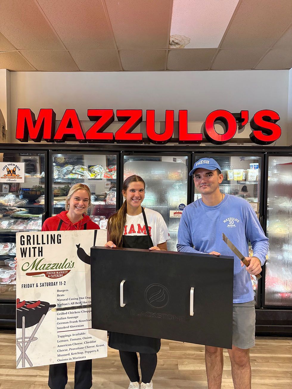 People posing outside Mazzulo's Market