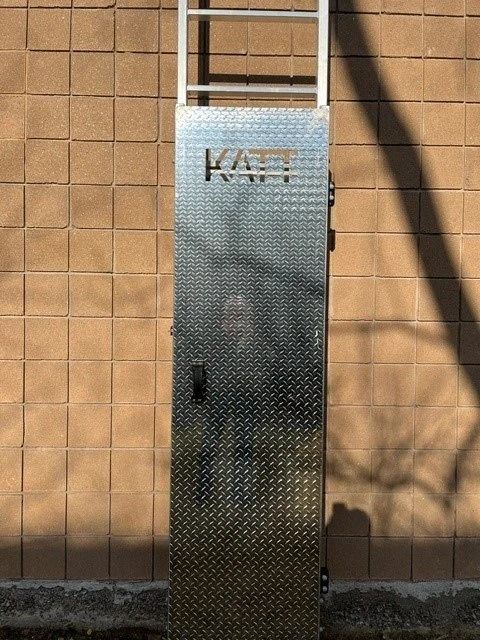 A metal ladder security cover with the brand name 