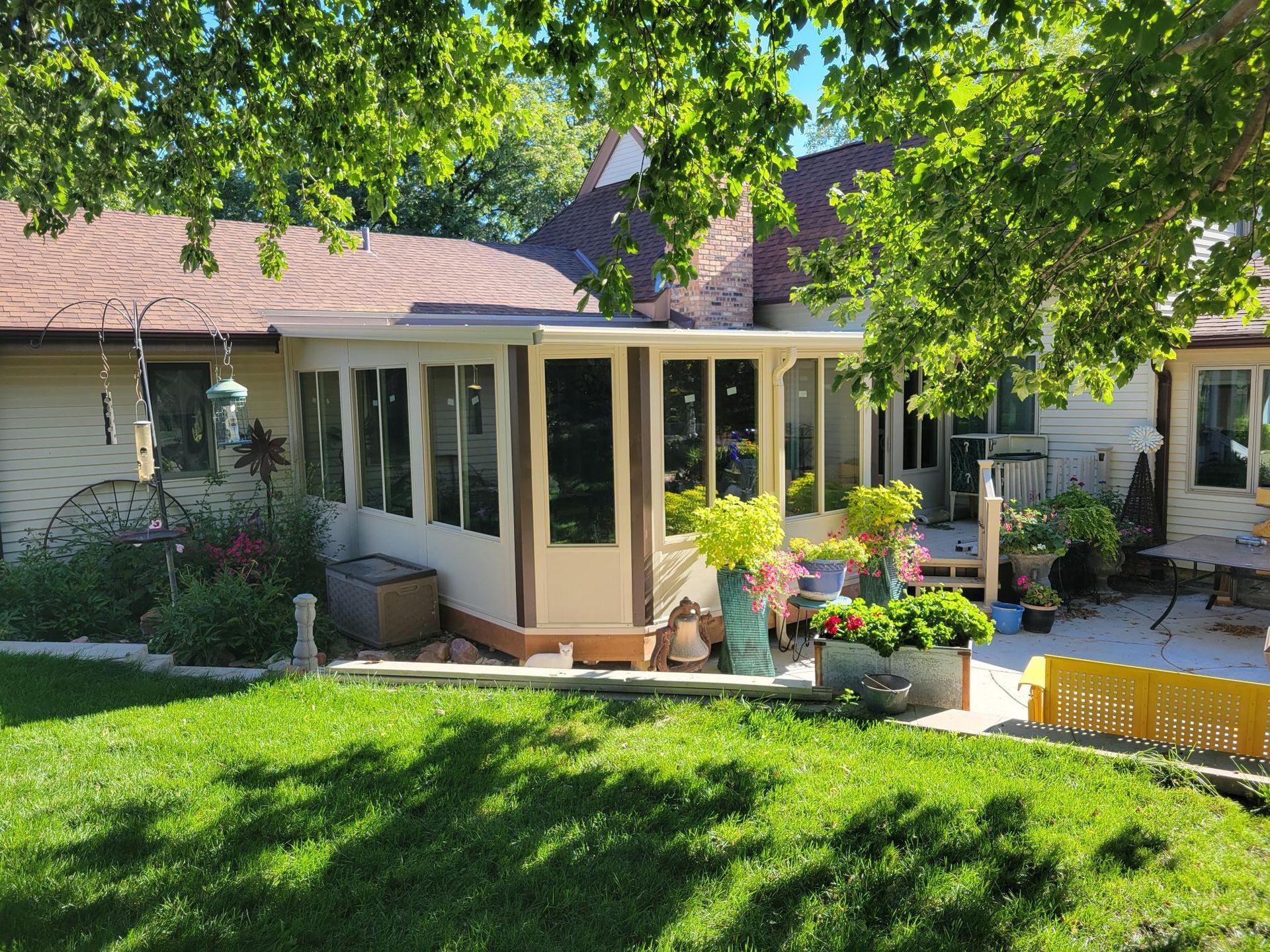 A house with a sunroom and patio cover.