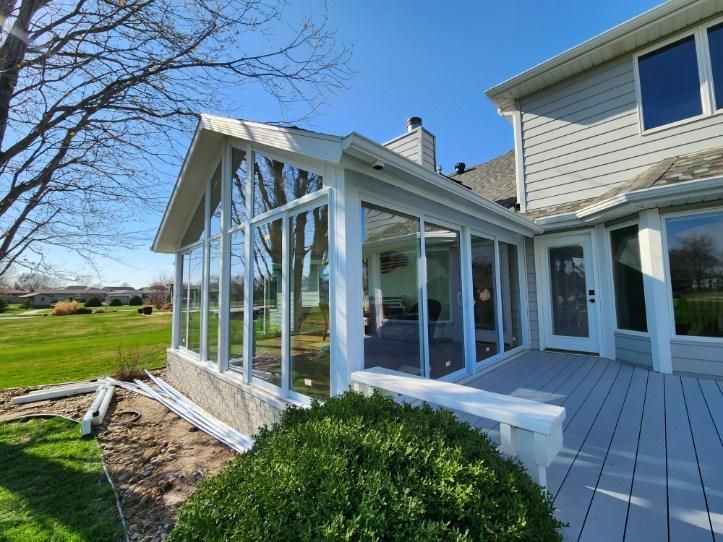 A house with sunroom and a deck