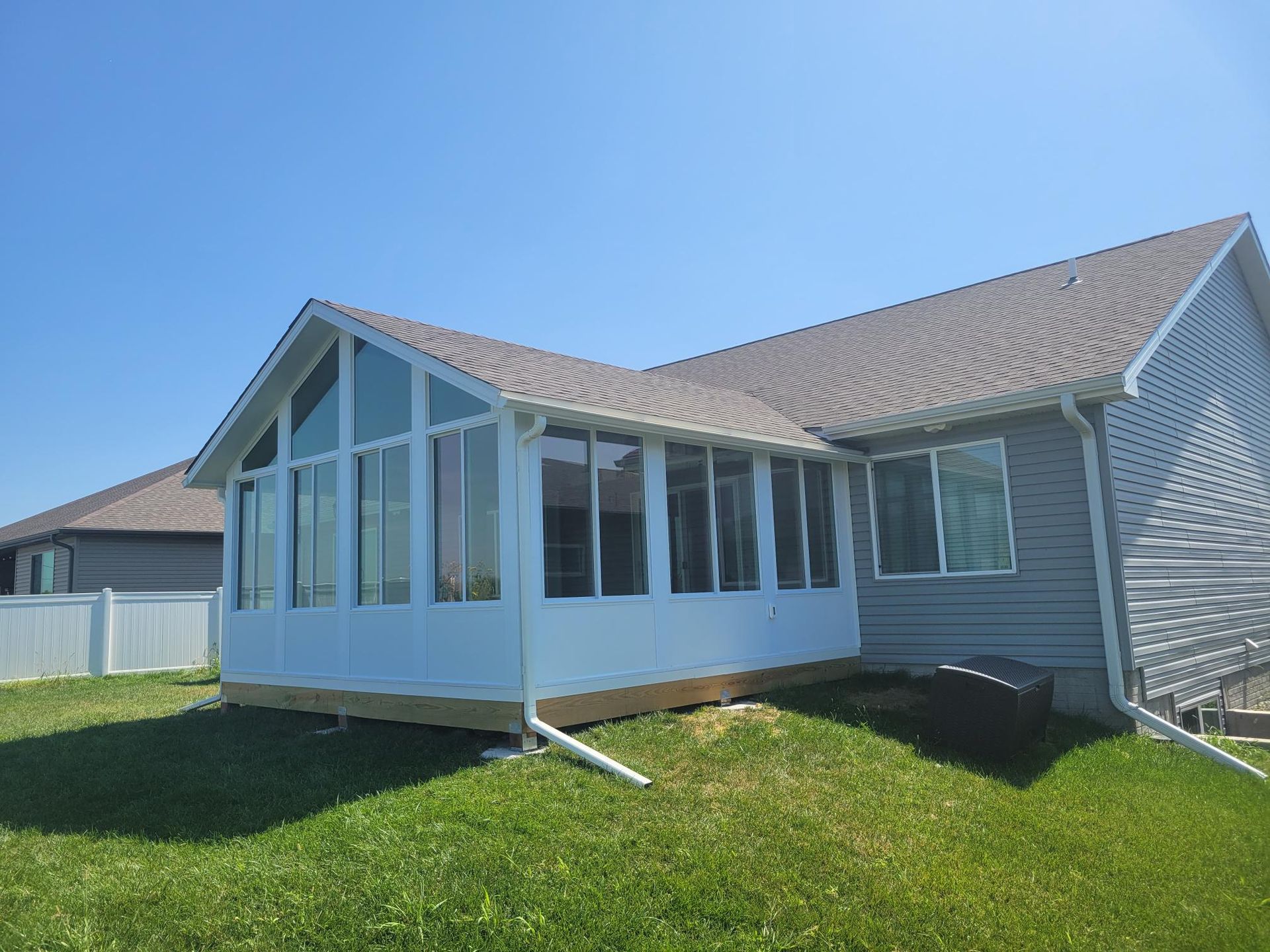A house with a sunroom in the backyard