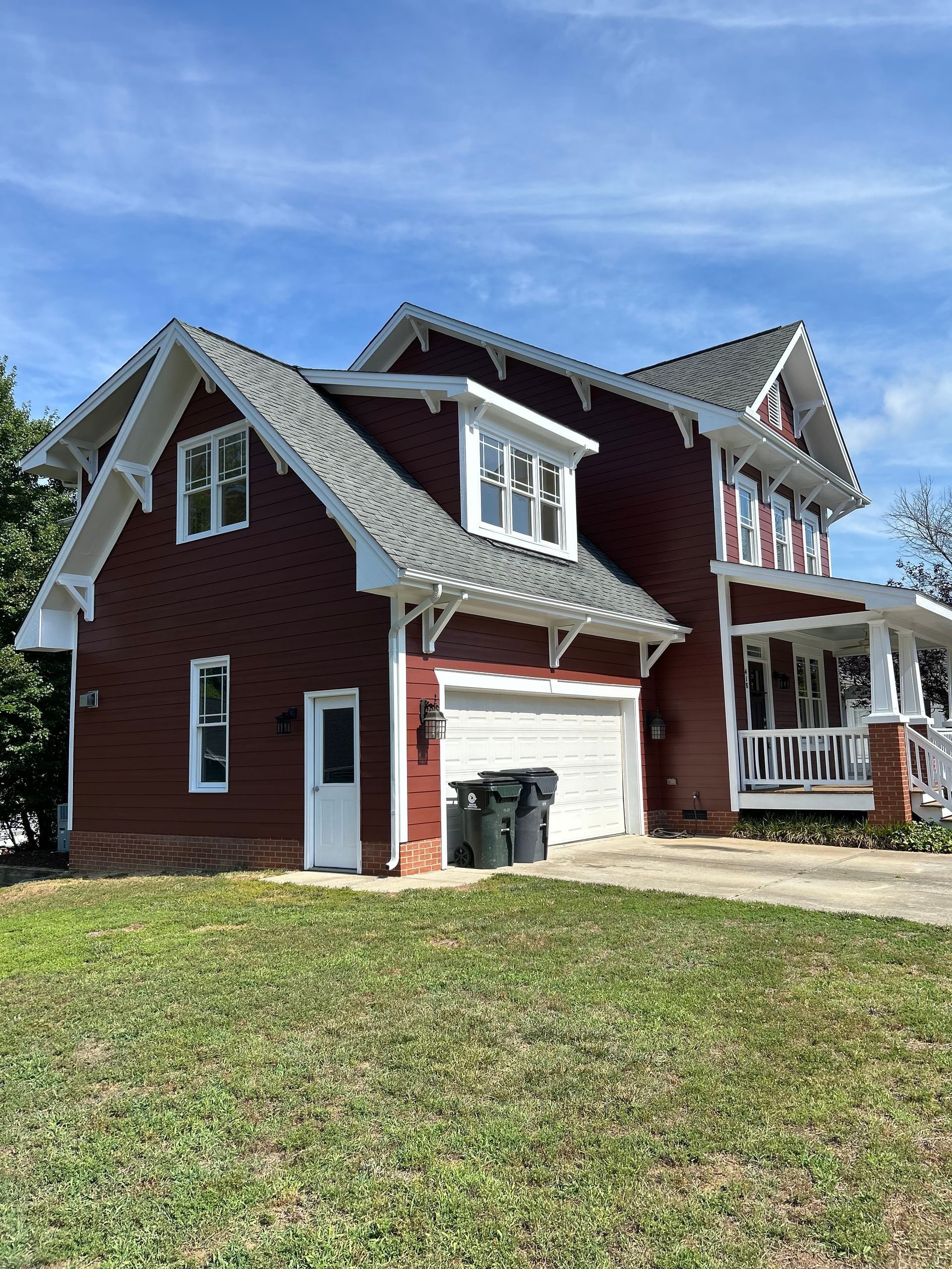 A large red brick house with a white garage door