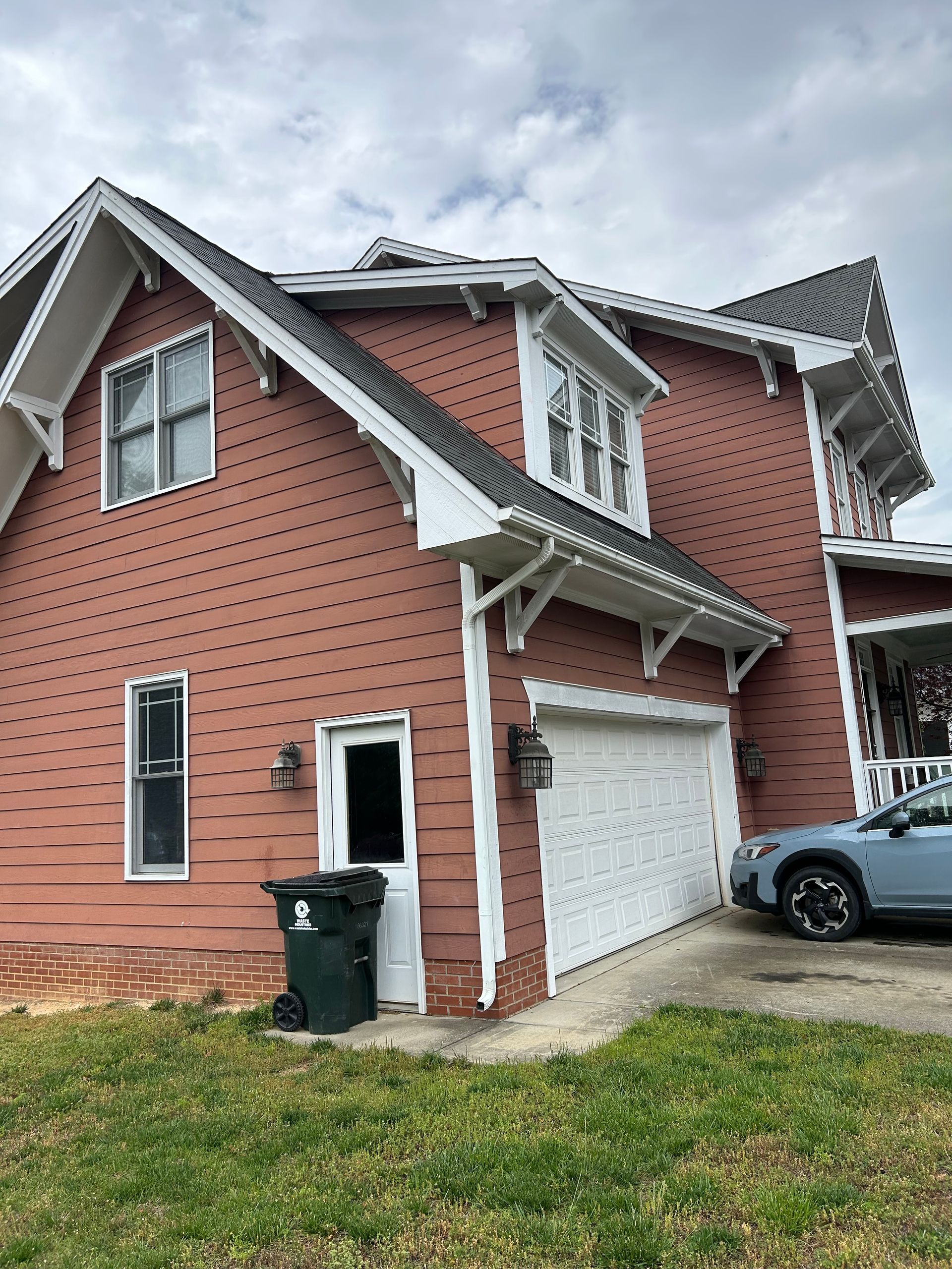 A large house with a car parked in front of it