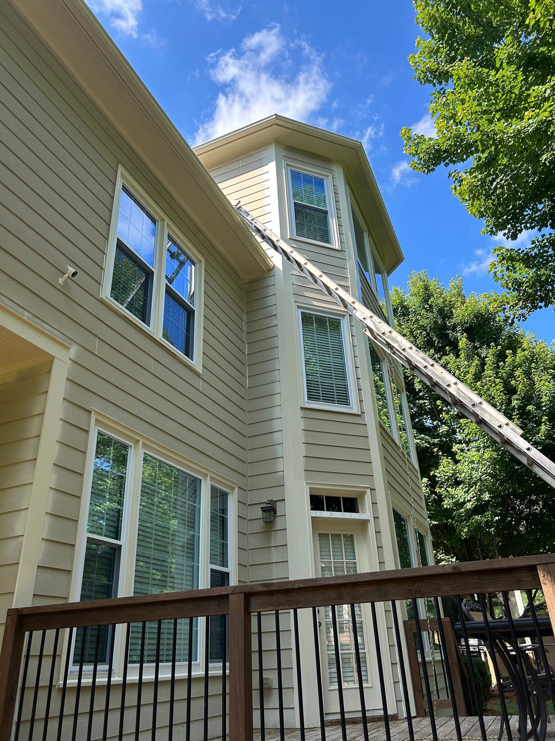 A large house with a ladder hanging from the side of it