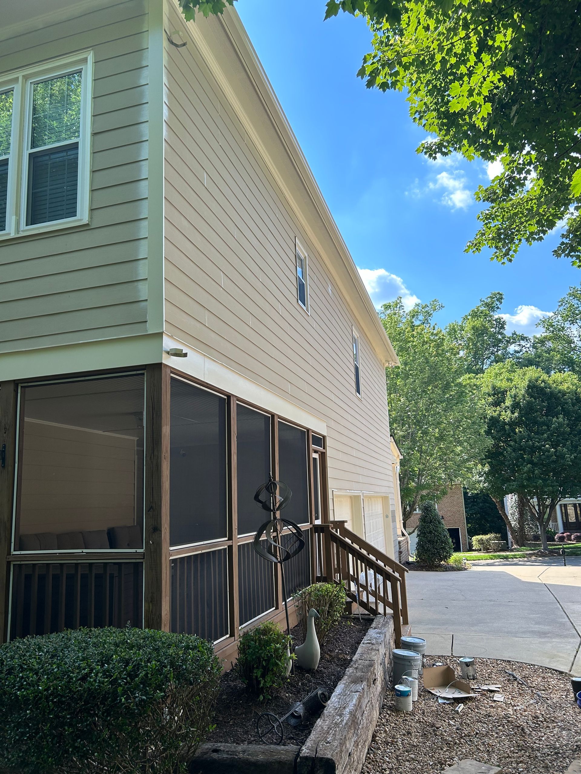 A house with a screened in porch and stairs