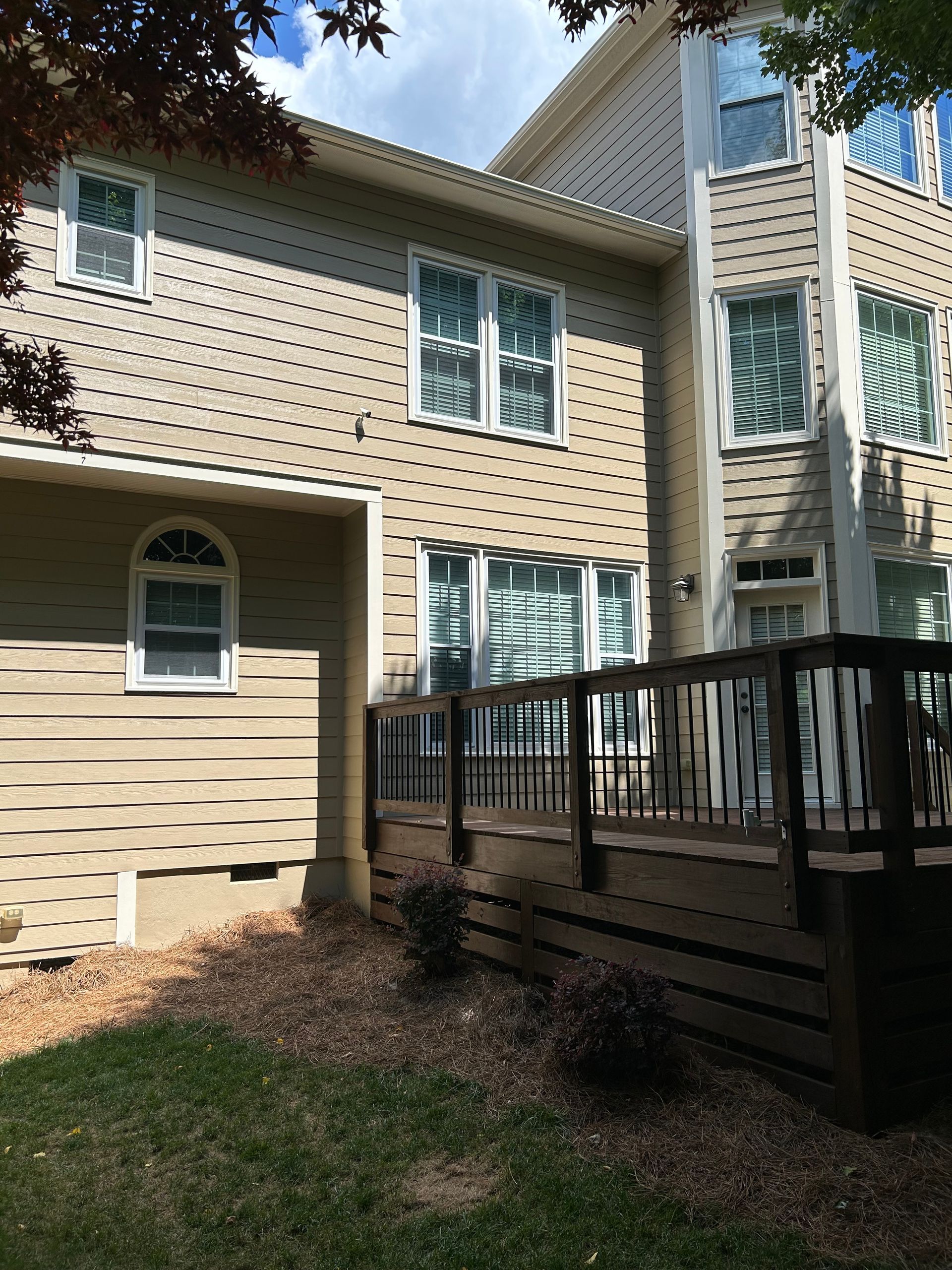 A large house with a deck in front of it