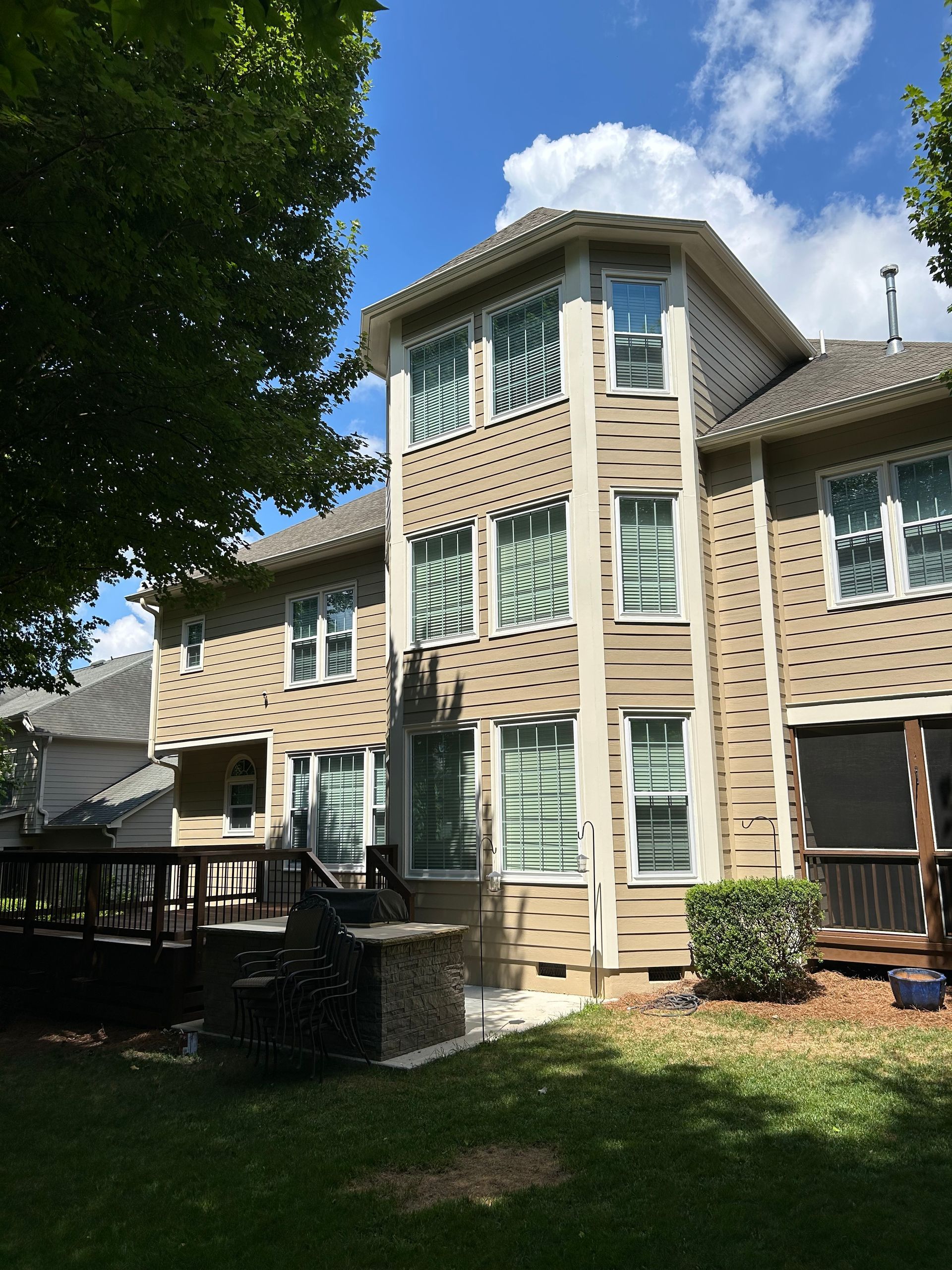 A large house with a lot of windows and a deck