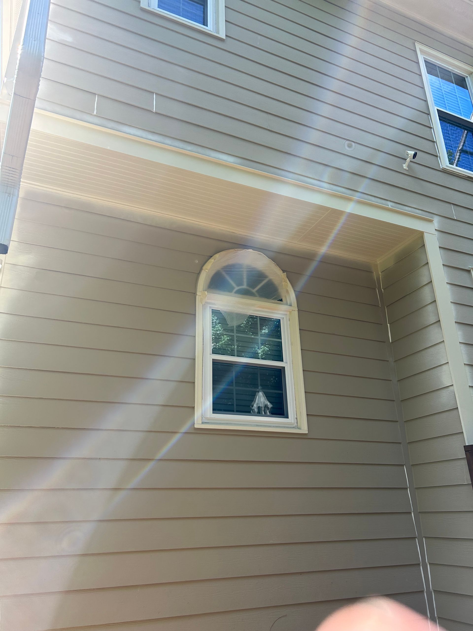 A person is holding a picture of a house with a window