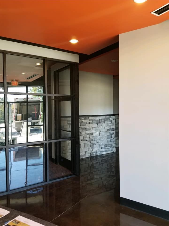 A room with a red ceiling and a lot of windows