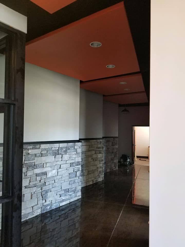 A hallway with brick walls and a red ceiling