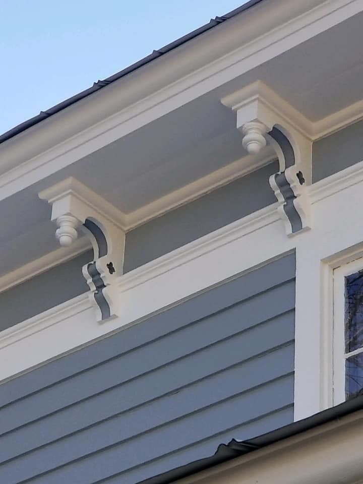 A blue house with white trim and a window