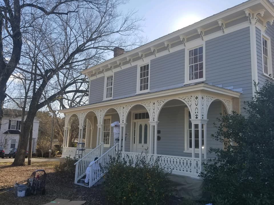 A large house with a large porch and stairs