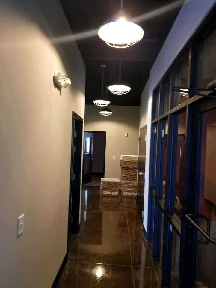 A hallway with a lot of lights hanging from the ceiling