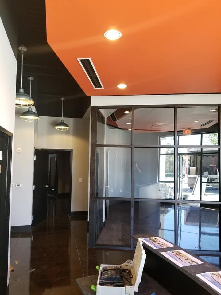 An empty room with a red ceiling and black walls