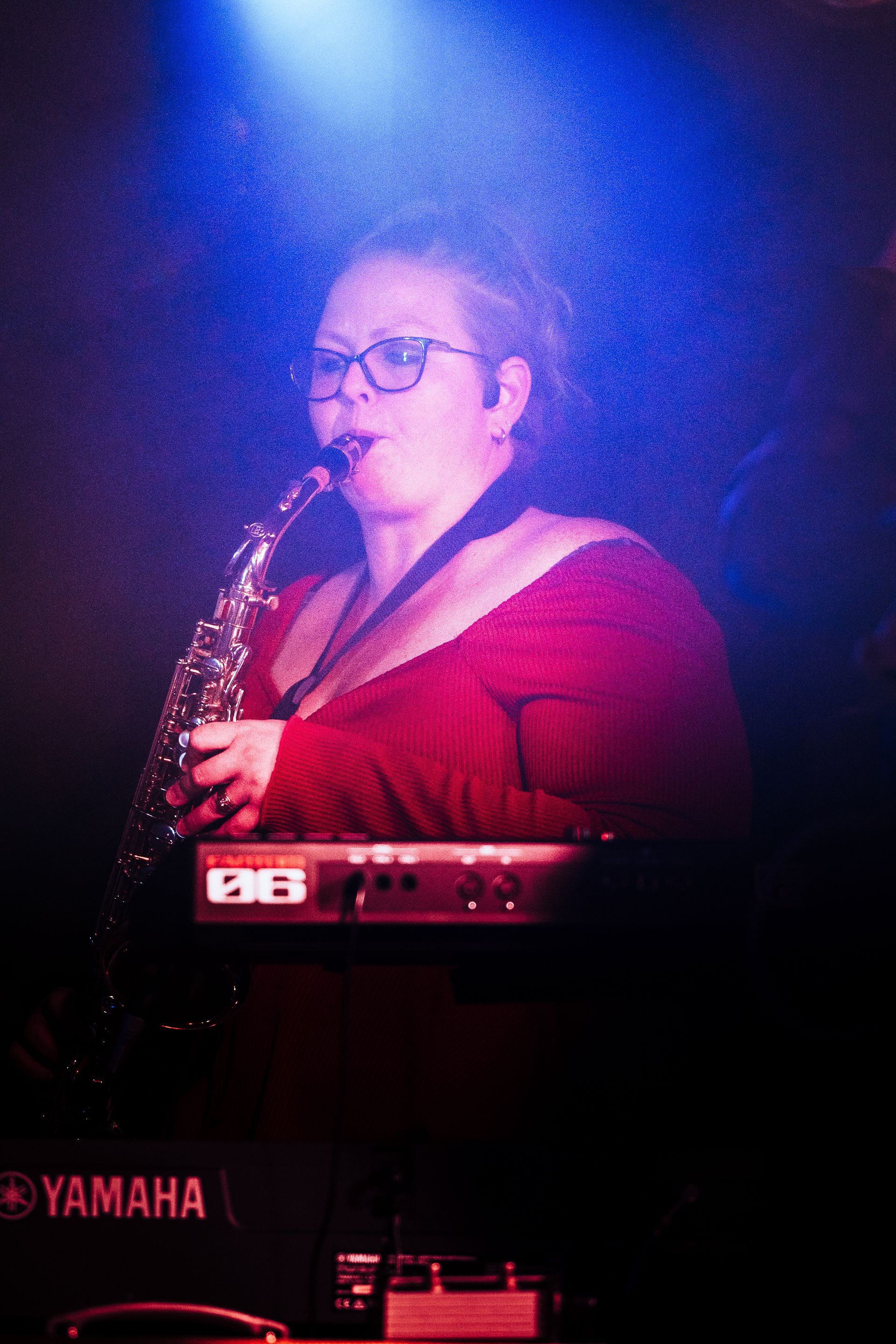 A woman is playing a saxophone 