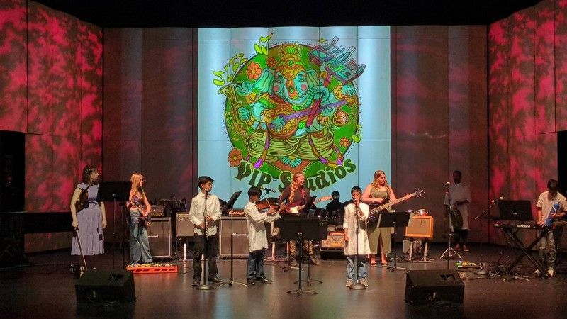 A group of people are playing instruments on a stage.