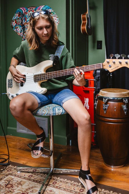 A musician playing a bass guitar
