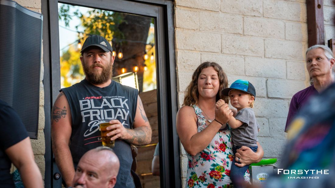 A group of people are standing outside of a building.