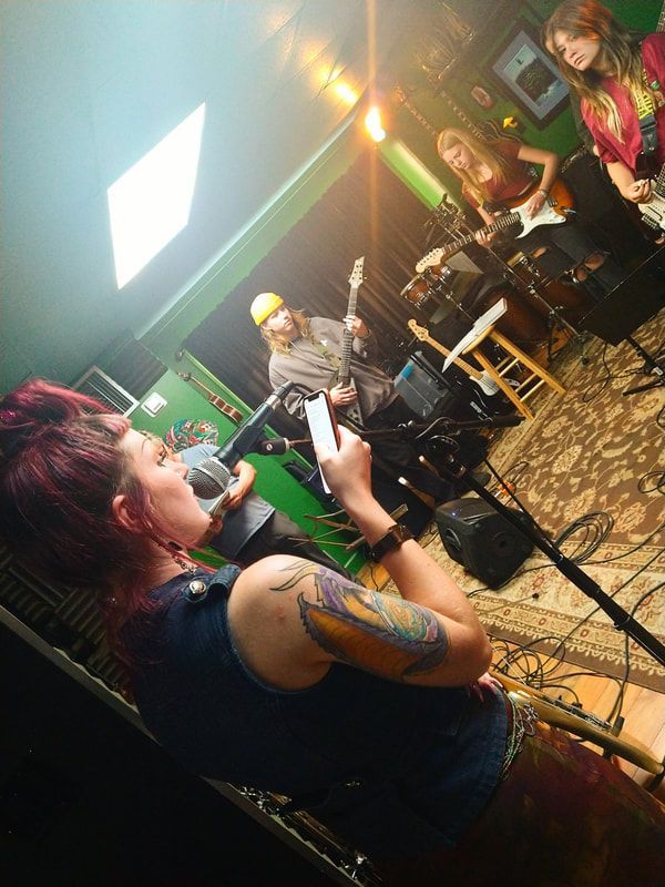 A group of people are playing instruments in a room.