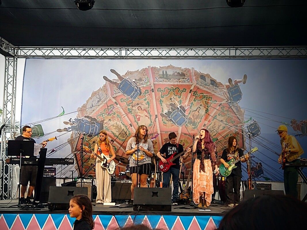 A group of people are playing instruments on a stage