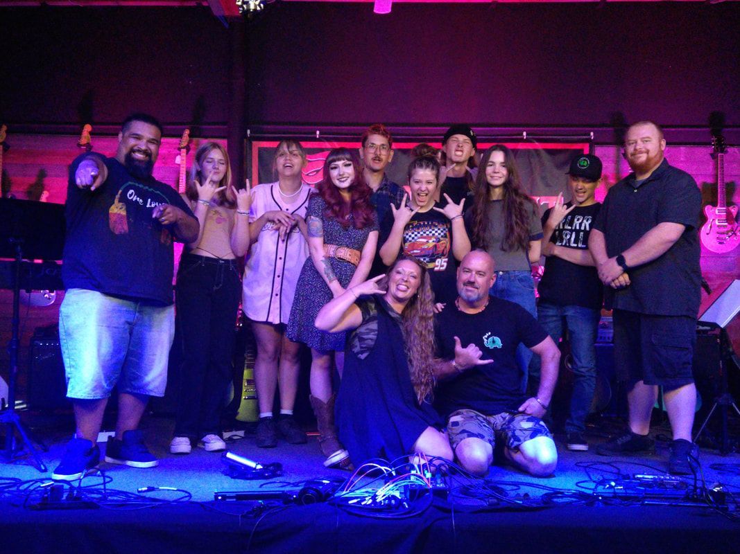 A group of people are posing for a picture on a stage.