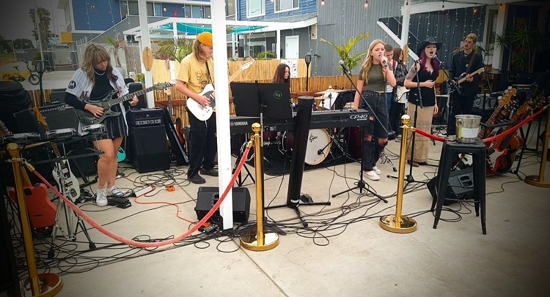 A group of people are playing instruments on a stage.