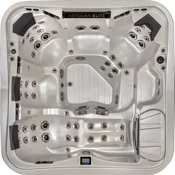 Top-down view of a white luxury hot tub with multiple black jets and built-in seats