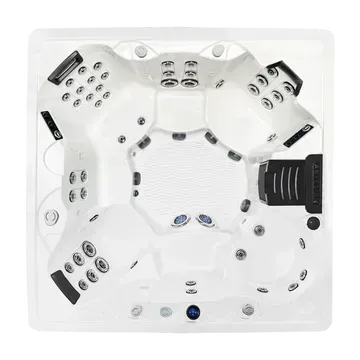 White hot tub with multiple seats, jets, and black control panels, viewed from above