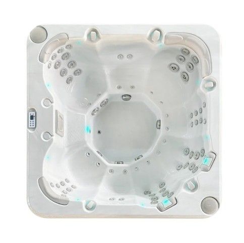 Top-down view of a white hot tub with multiple jets and built-in seats