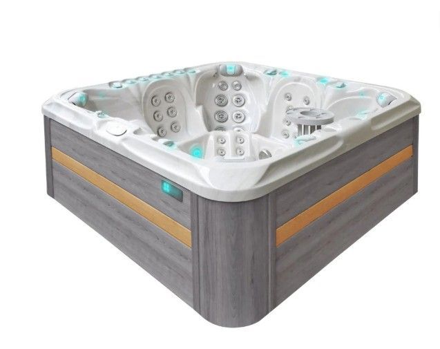 Modern gray-and-white corner hot tub with multiple seats and control panel