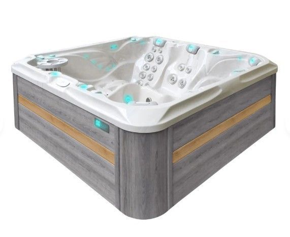 White and gray two-person hot tub with blue-lit controls and wood-paneled sides
