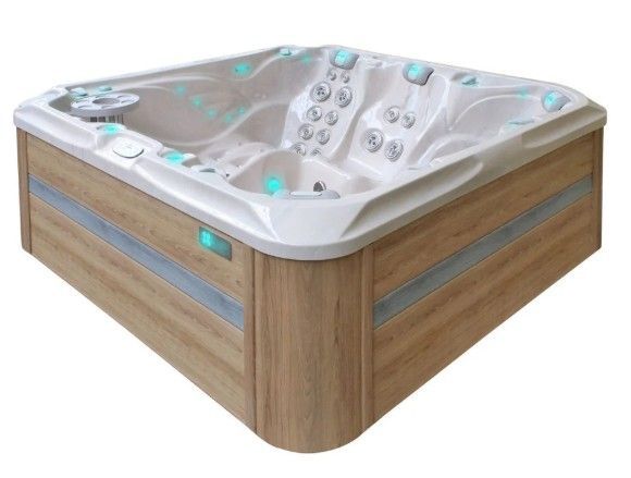 Wood-paneled corner hot tub with white interior and teal-lit jets