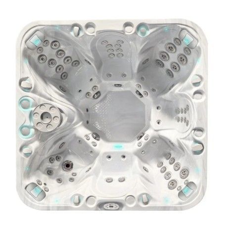 Clear acrylic hot tub with multiple seats, jets, and blue-lit controls, viewed from above
