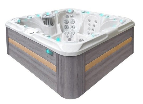White corner hot tub with gray wood-paneled sides and turquoise jets