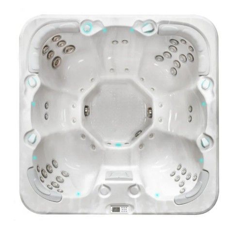Top-down view of a white square hot tub with multiple jet nozzles and molded seats