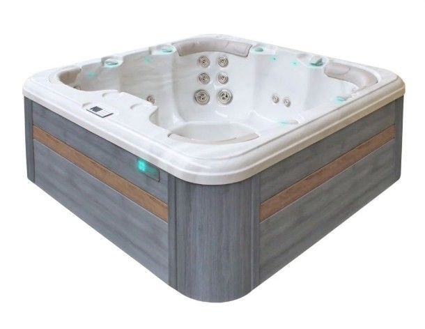 Modern gray and white corner hot tub with built-in seats and jets