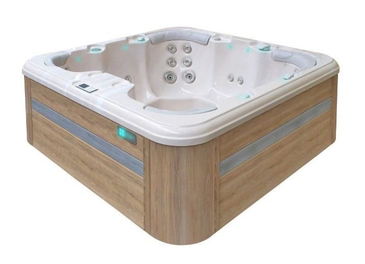 Wood-paneled corner hot tub with white interior and multiple jets