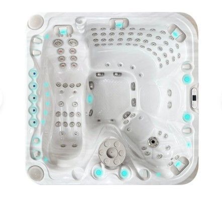 White hot tub spa with multiple seats, jets, and aqua-blue accents, viewed from above