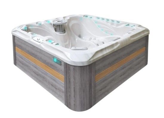 White and gray square hot tub with wood-look siding and built-in jets, on a white background