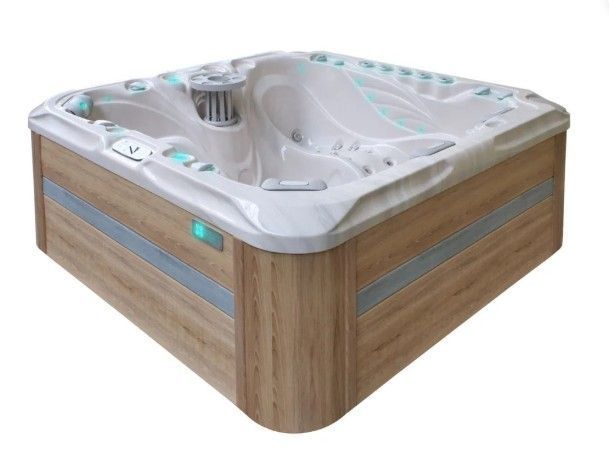 Wood-paneled corner hot tub with white interior and built-in jets
